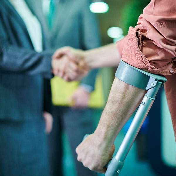 injured person shaking lawyer's hand
