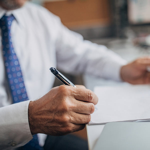 man signing contract