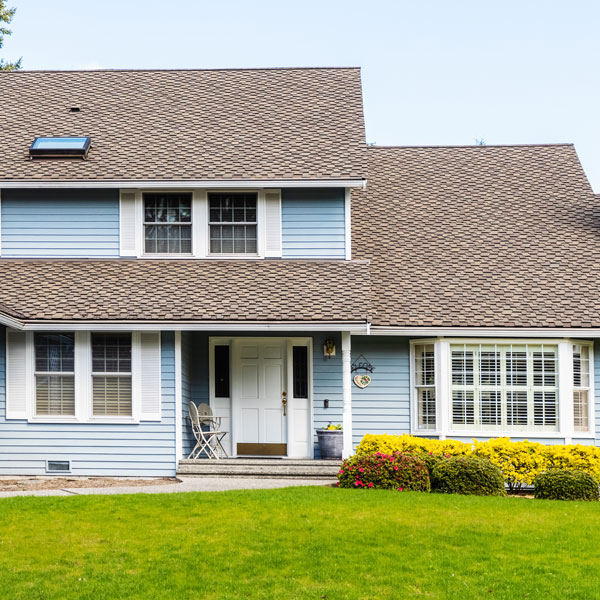 blue house and bright green grass